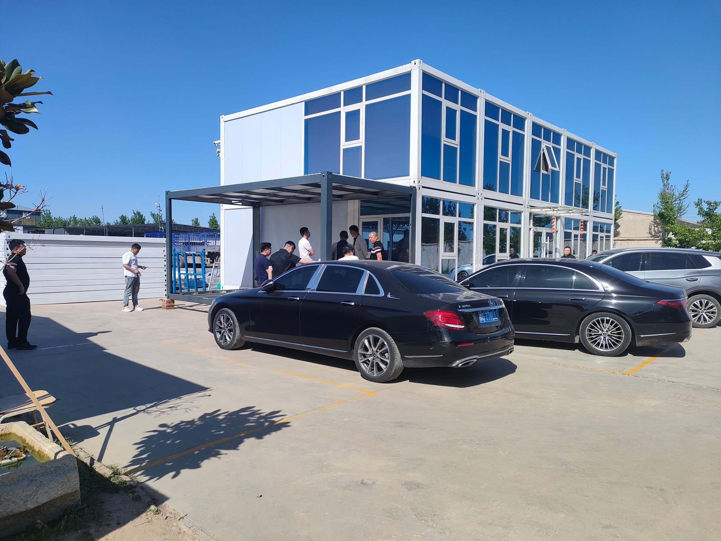Manufacturing facility exterior with panel stock and gantry crane