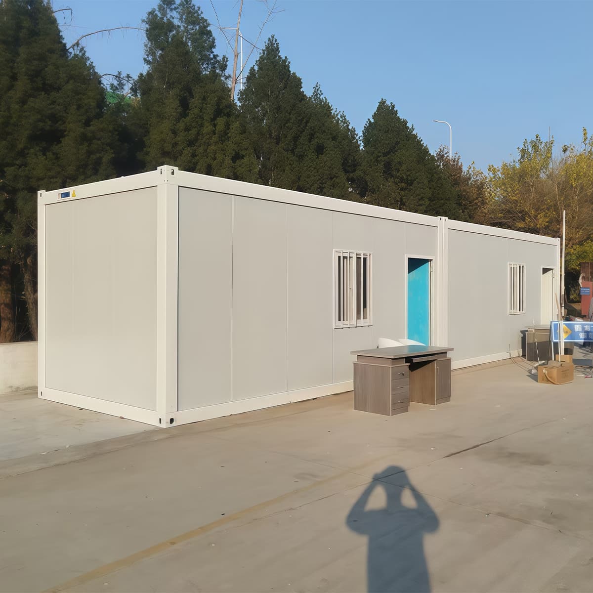 Compact site cabin structure with panel doors open, representative of the portable office cabin shell